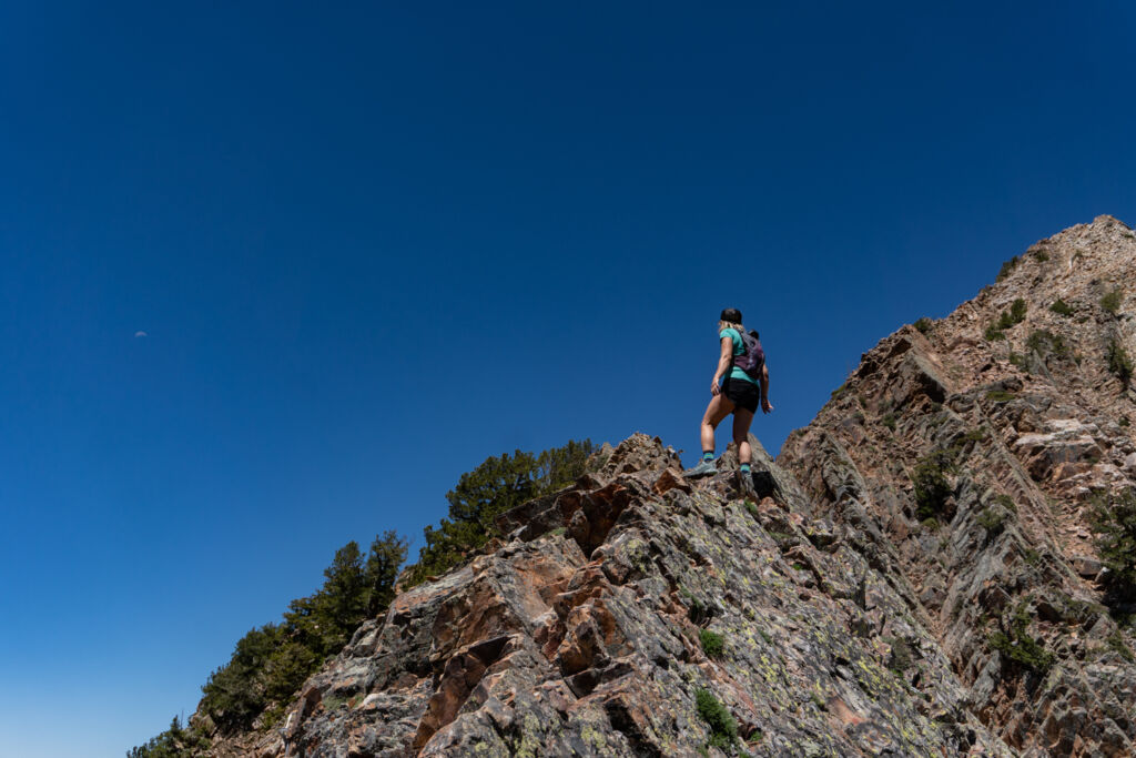female hiker scrambling south ridge of Mt. Superior Utah